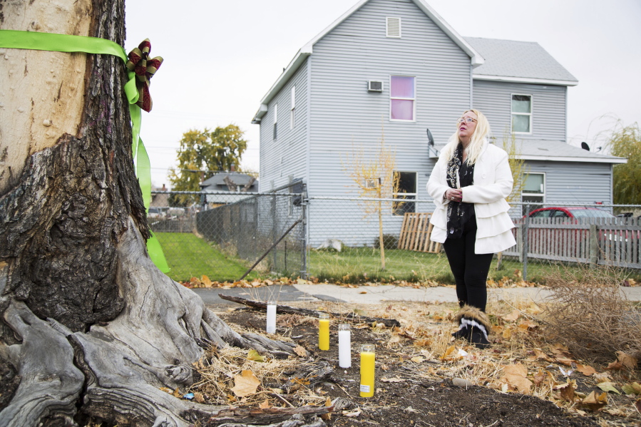 Elizabeth Ramos is emotional after setting up a memorial of ribbons, candles and flowers for her stepsister, Theresa Lumley, near East Spruce and South Sixth streets Nov. 4 in Yakima. Lumley was killed in a hit-and-run near the site on Oct. 28.