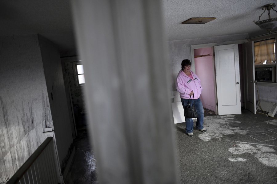 City Council Member Karen Stratton walls through her deceased aunt’s former home on Nov. 7 in Spokane. She is at the end of a two-year battle to get a squatter evicted from the residence.