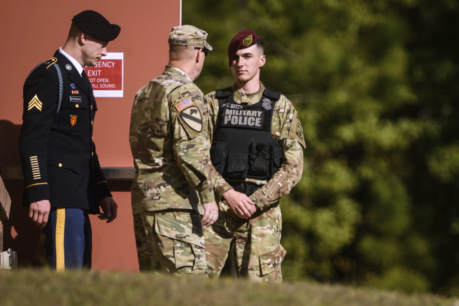 Sgt. Bowe Bergdahl, left, leaves the Fort Bragg courtroom facility after a sentencing hearing on Tuesday on Fort Bragg, N.C. Bergdahl faces up to life in prison after pleading guilty to desertion and misbehavior before the enemy for walking off his remote post in Afghanistan in 2009.