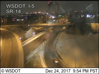 Traffic approaches the southbound span of the Interstate 5 Bridge on a snowy, icy Christmas Eve.