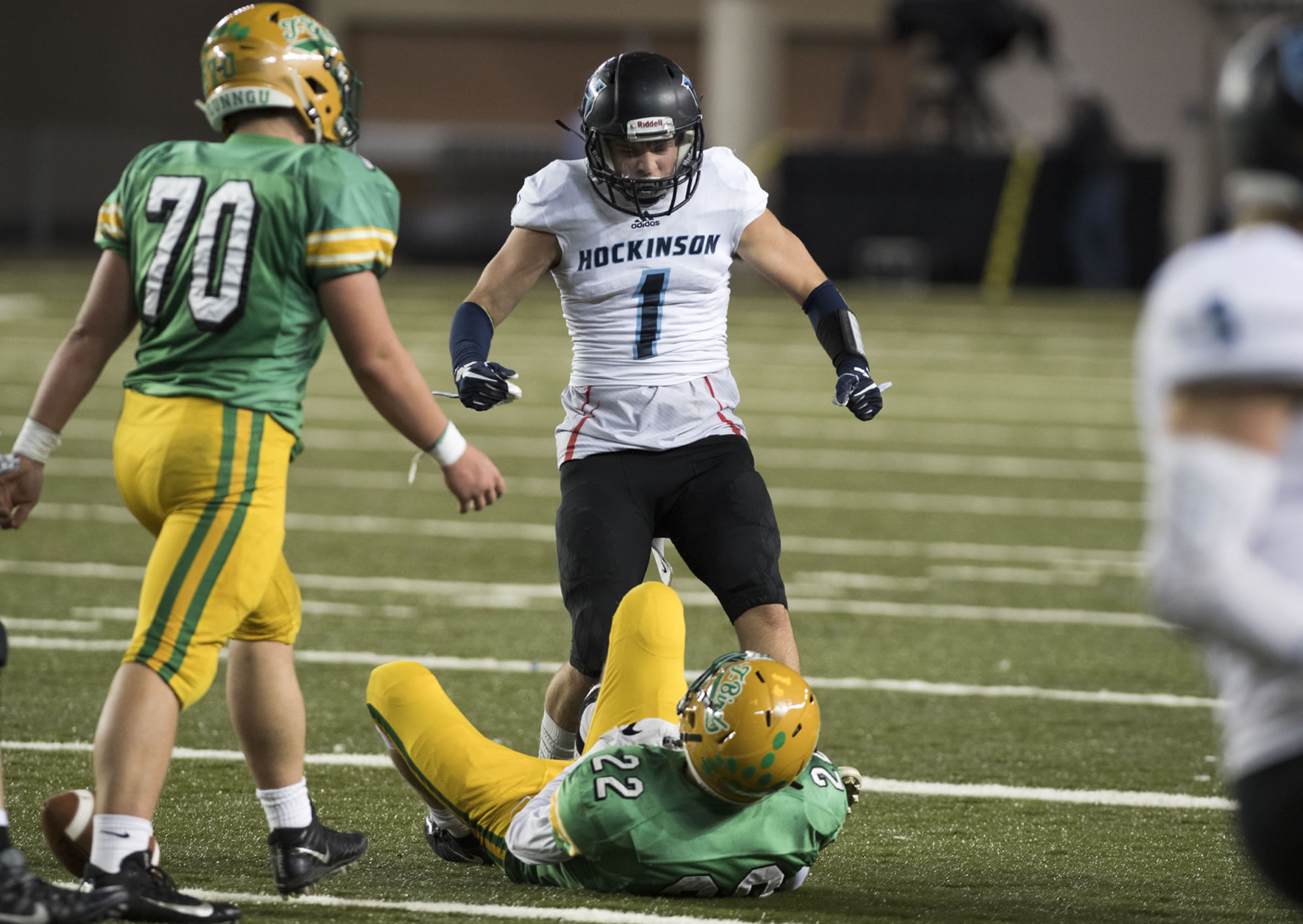 Hockinson's Aidan Mallory (1) celebrates a tackle against Tumwater's Jakob Holbrook (22) during the 2A State Football Championship game Saturday, Dec. 2, 2017, in Tacoma, Wash.