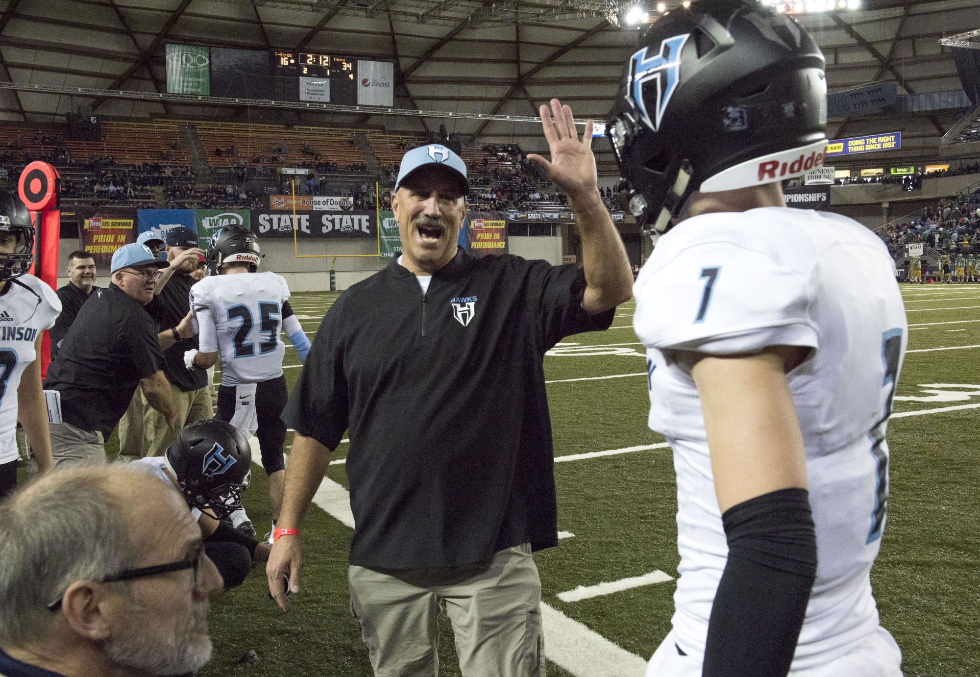 Hockinson head coach Rick Steele congratulates Aidan Mallory (1) after Mallory's interception and touchdown against Tumwater during the 2A state football championship game Saturday, Dec. 2, 2017, in Tacoma, Wash.