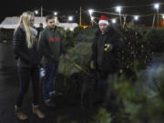 Vancouver residents Kate Lawrence, left, and Brian Dugan shop for a Christmas tree at Bo’s Trees on Northeast 78th Street and Highway 99 in Hazel Dell.