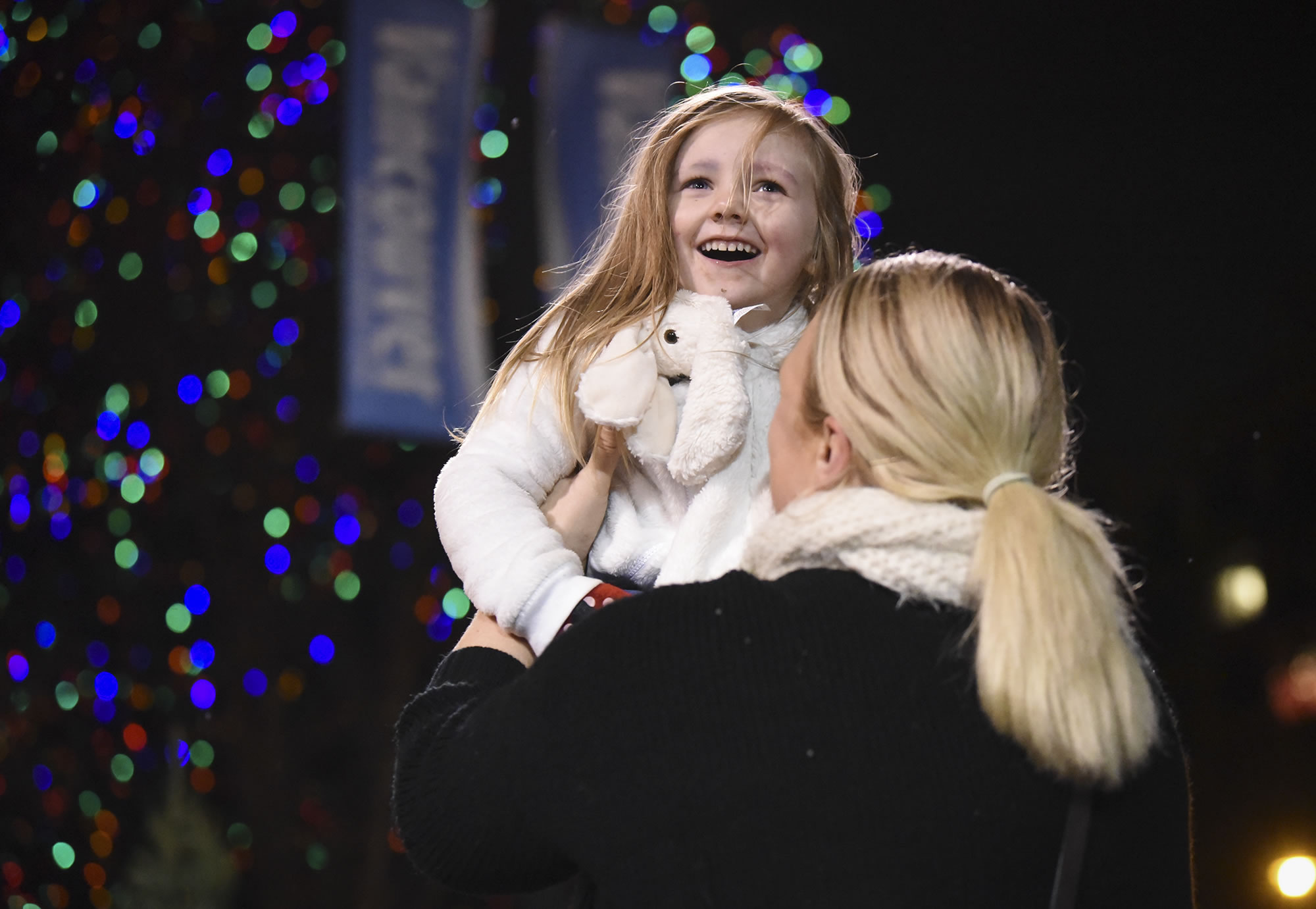 Claire Woodman, 3, smiles as her mother, Christina Sanderson, tosses her in the air at Activate Church’s sixth annual Christmas at the Park in Esther Short Park.