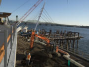 The Grant Street Pier at The Waterfront Vancouver is starting to take shape as construction crews attach the pier cables Thursday. Two restaurant buildings and the pier are on pace to open in July, officials said.