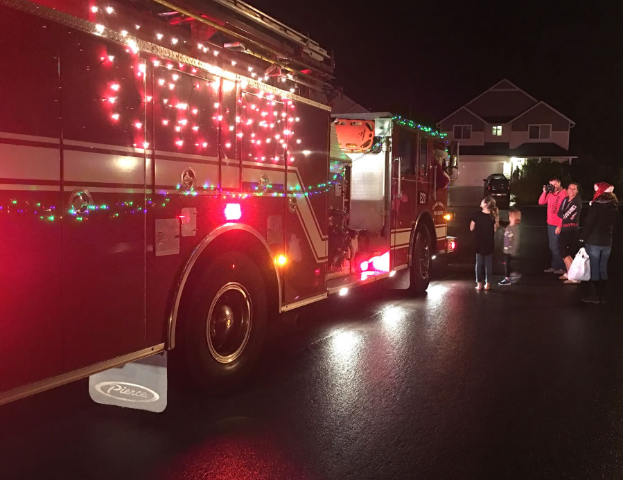 La Center: A reserve Clark County Fire & Rescue engine was decorated for the holidays, while volunteers drove Santa around La Center.