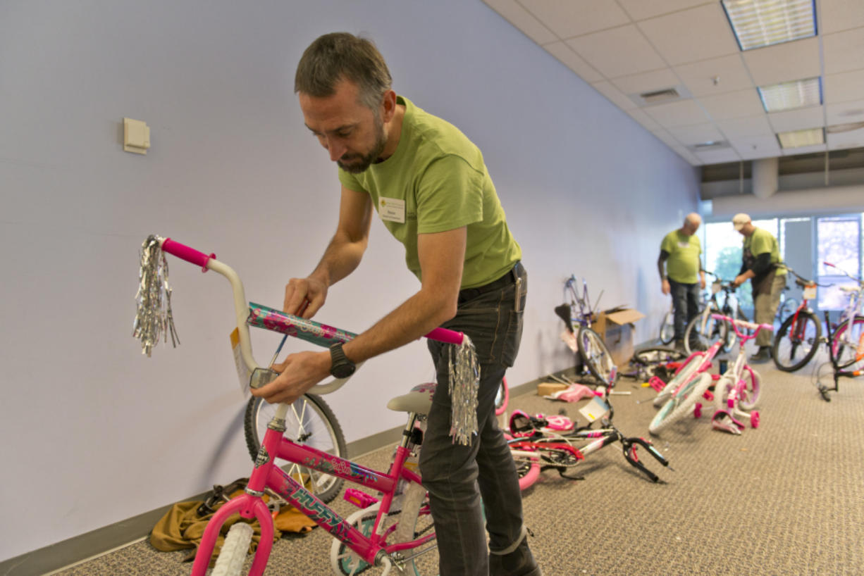 The 18th annual Vancouver Bike Build, sponsored in part by Waste Connections, was able to build 605 bicycles for needy children with the help of about 200 volunteers. Peter Van Tilburg, of Bike Clark County, puts the finishing touches on a bicycle for donation.
