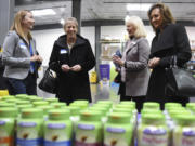 Doris Meade, from left, of Church & Dwight Co. Inc., Clark County councilors Julie Olson and Eileen Quiring, and state Sen. Lynda Wilson, R-Vancouver. On Thursday, public officials toured the Vancouver plant where gummy vitamins are made.