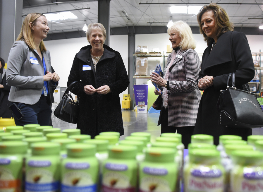 Doris Meade, from left, of Church & Dwight Co. Inc., Clark County councilors Julie Olson and Eileen Quiring, and state Sen. Lynda Wilson, R-Vancouver. On Thursday, public officials toured the Vancouver plant where gummy vitamins are made.
