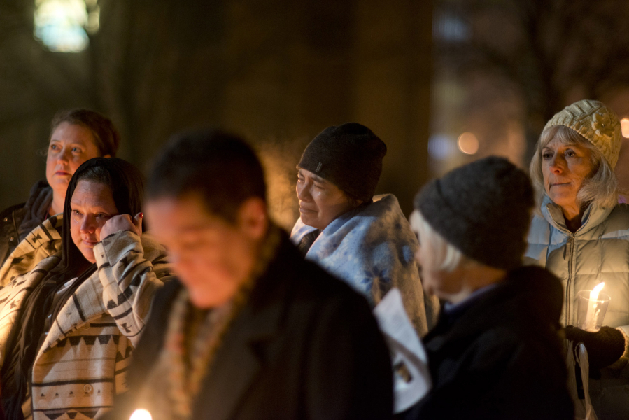 Deanna Huynh, center, of Vancouver, reacts when the name of her friend, Matt Solop, is read. Solop was one of 17 homeless people who died in Clark County in the past year.