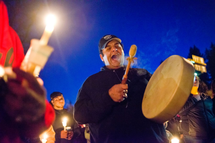 Rick Bear Montoya, a friend of James Rennells, sings a song for Rennells during a candlelight vigil Saturday near Leverich Park in Vancouver. Rennells was found dead near the park Wednesday after being missing for nearly a week.