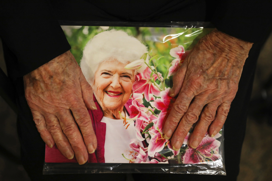 Essie Fleisch, a resident at the Summit at First Hill senior home, holds a copy of her photo, given to her for particating in the show “Faces of the Summit,” a project consisting of over 20 portraits of residents all between the ages of 85 and 102, Sunday, Nov. 5, 2017, in Seattle. The portraits are accompanied by participants’ reflections on aging, and other experiences. The show, funded by a private donor, is not open to the public, but is for residents and their visitors.