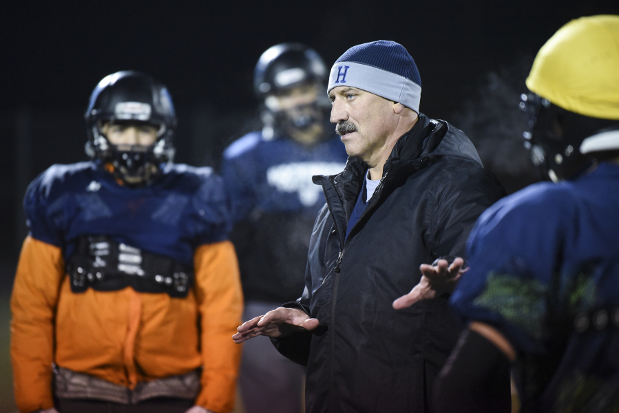 Hockinson Head Coach Rick Steele explains a strategy to Hockinson players during practice at Battle Ground District Stadium on Tuesday.
