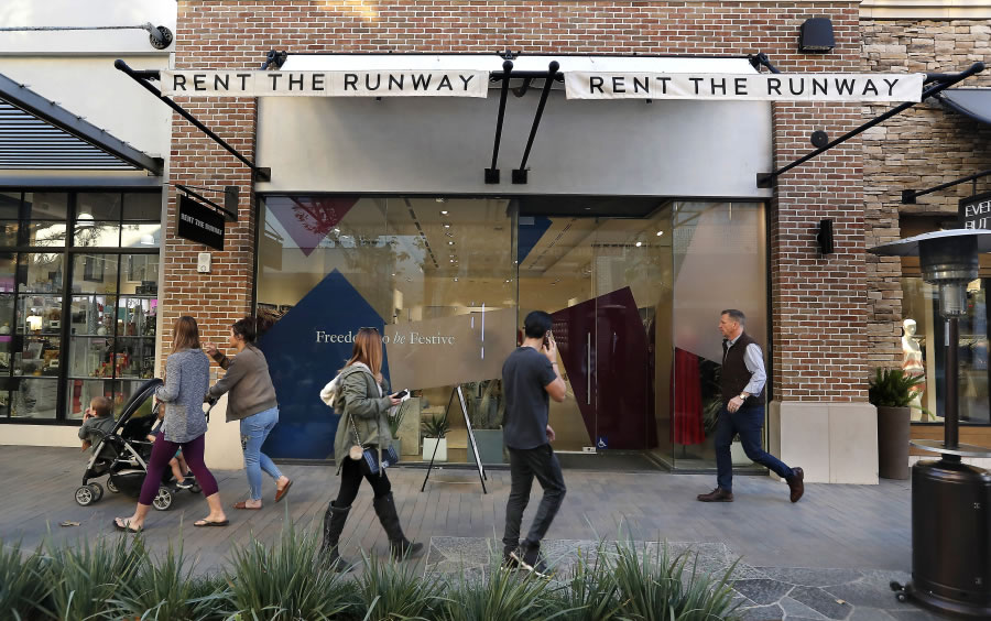 People walk past the Rent the Runway store located at the Village at Westfield Topanga shopping mall in Woodland Hills, Calif.