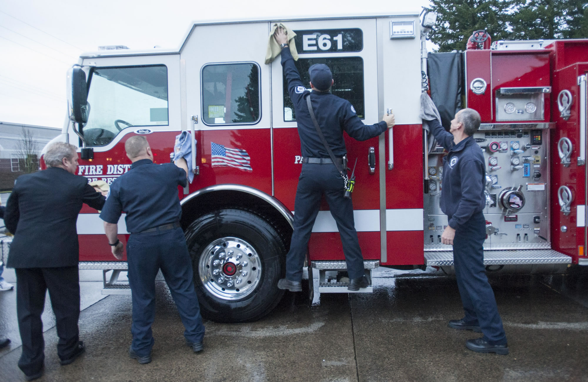 Firefighters with Fire District 6 wash a new fire engine in Hazel Dell in January 2016.