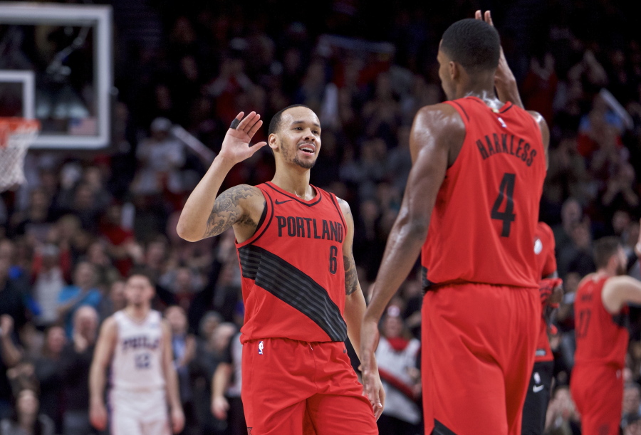 Portland Trail Blazers guard Shabazz Napier, left, and forward Maurice Harkless high-five during the second half of the team's NBA basketball game against the Philadelphia 76ers in Portland, Ore., Thursday, Dec. 28, 2017.