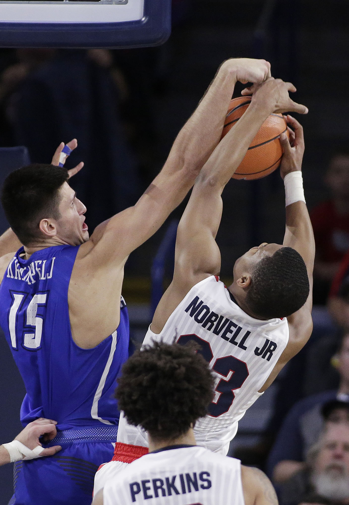 Creighton forward Martin Krampelj (15) and Gonzaga guard Zach Norvell Jr. go after a rebound during the second half of an NCAA college basketball game in Spokane, Wash., Friday, Dec. 1, 2017. Gonzaga won 91-74.