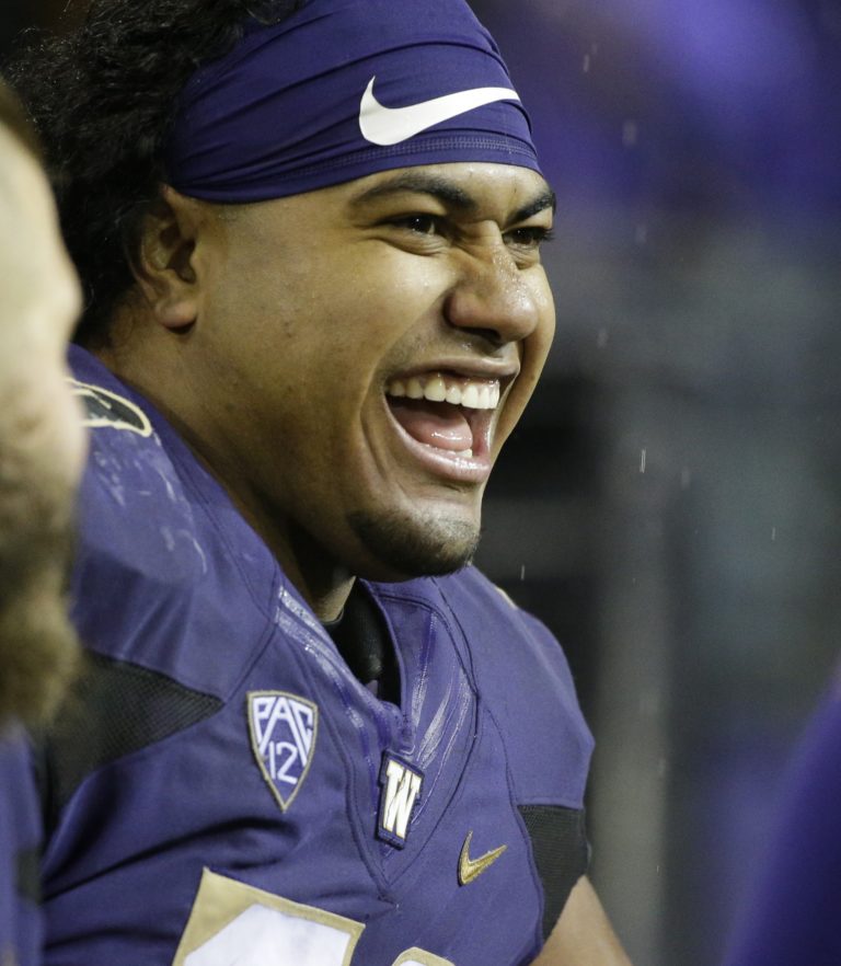 Washington defensive lineman Vita Vea, right, sits on the sideline during an NCAA college football game against Oregon, Saturday, Nov. 4, 2017, in Seattle. (AP Photo/Ted S.