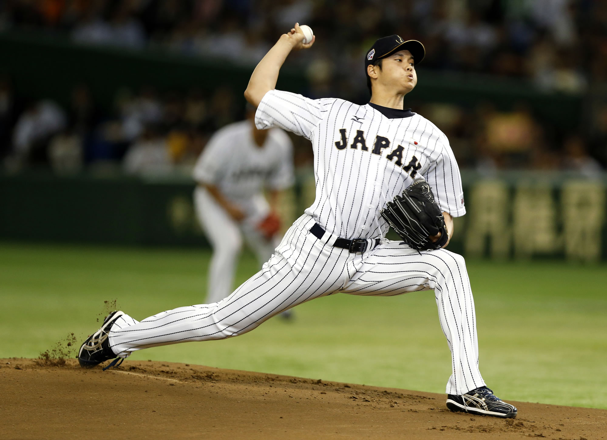 Japanese star Shohei Ohtani is bringing his arm and bat to the Los Angeles Angels. Ohtani's agent put out a statement Friday, Dec. 8, 2017, saying the prized two-way player had decided to sign with the Angels, a surprise winner over Seattle, Texas and several other teams.