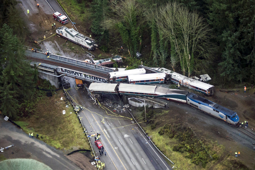 Cars from an Amtrak train that derailed lie spilled onto Interstate 5, Monday, Dec. 18, 2017, in DuPont, Wash. The Amtrak train making the first-ever run along a faster new route hurtled off the overpass Monday near Tacoma and spilled some of its cars onto the highway below, killing several people, authorities said.