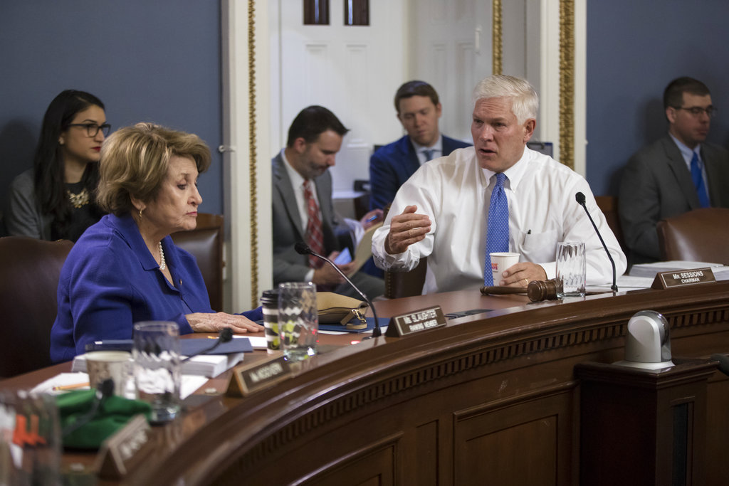 House Rules Committee Chairman Pete Sessions, R-Texas, right, confers with Rep. Louise Slaughter, D-N.Y., the top Democrat, as the panel meets early Wednesday, Dec. 20, 2017, to approve some procedural corrections in the final version of the Republican tax bill, on Capitol Hill, in Washington. (AP Photo/J.