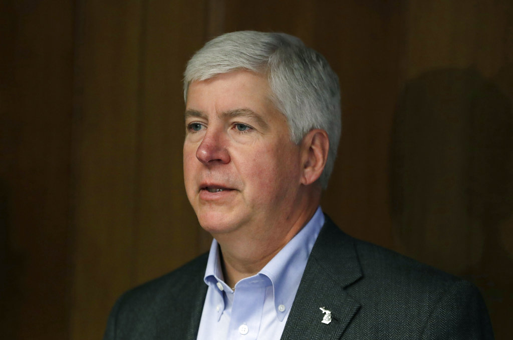 FILE - In this March 13, 2017, file photo, Michigan Gov. Rick Snyder speaks during a news conference in Detroit. With Congress sending President Donald Trump a tax overhaul, state and local governments are preparing for some fallout.  Snyder said Thursday, Dec. 21, that an individual in his state could owe $170 more in state taxes and a married family of four an additional $680 as a result of eliminating the personal exemption. He wants lawmakers to work on a fix in the coming year.