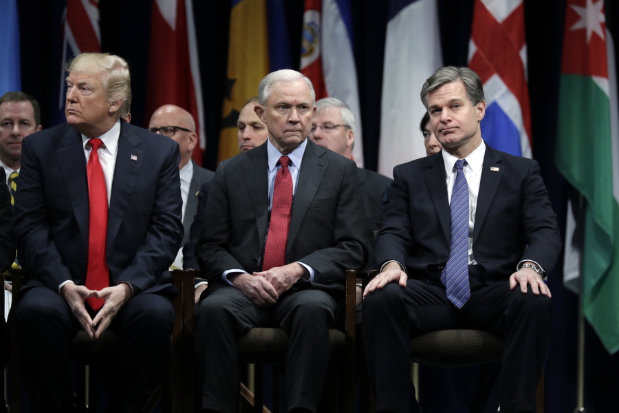 President Donald Trump, left, Attorney General Jeff Sessions, center, and FBI Director Christopher Wray sit together at the FBI National Academy graduation ceremony Friday in Quantico, Va.