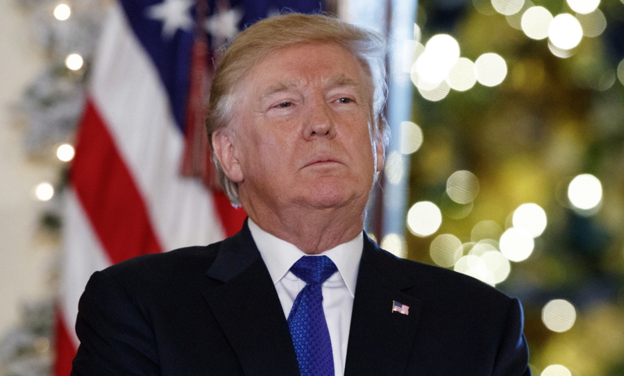 President Donald Trump listens people speak in support of Republican tax policy reform, during an event in the Grand Foyer of the White House, Wednesday, Dec. 13, 2017, in Washington. Americans are painting a pessimistic view of the country and President Donald Trump as 2017 comes to a close. That’s according to a new poll from The Associated Press-NORC Center for Public Affairs Research. The survey shows less than a quarter of Americans think Trump has made good on the pledges he made to voters while running for president.