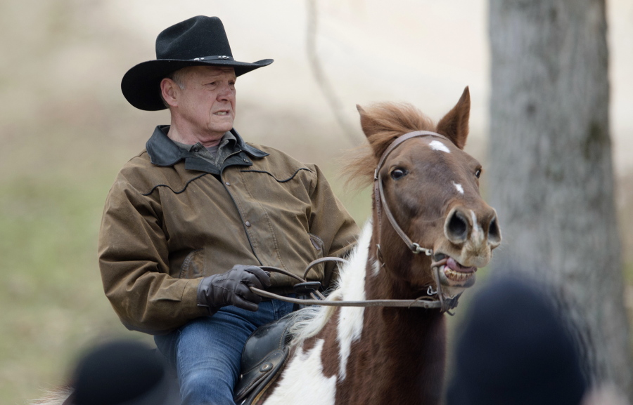 Republican senate nominee Roy Moore rides a horse to a polling station to cast his ballot in Alabama’s special Senate election, Tuesday, in Gallant, Ala.