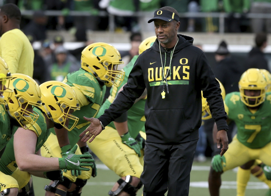 FILE - In this Nov. 18, 2017, file photo, Oregon head coach Willie Taggart, center, greets his players during warmups before an NCAA college football game against Arizona in Eugene, Ore. A person with direct knowledge of the situation says Willie Taggart has agreed to become Florida State's next football coach. The person says Taggart has called a team meeting to inform his Oregon players he is heading to Tallahassee to replace Jimbo Fisher. Florida State. The person spoke to The Associated Press Tuesday, Dec. 5, 2017, on condition of anonymity because neither school had announced the move.