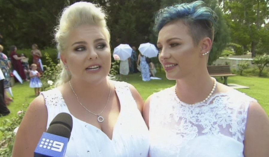 Newlyweds Amy Laker, left, and Lauren Price are interviewed during their ceremony Channel 9