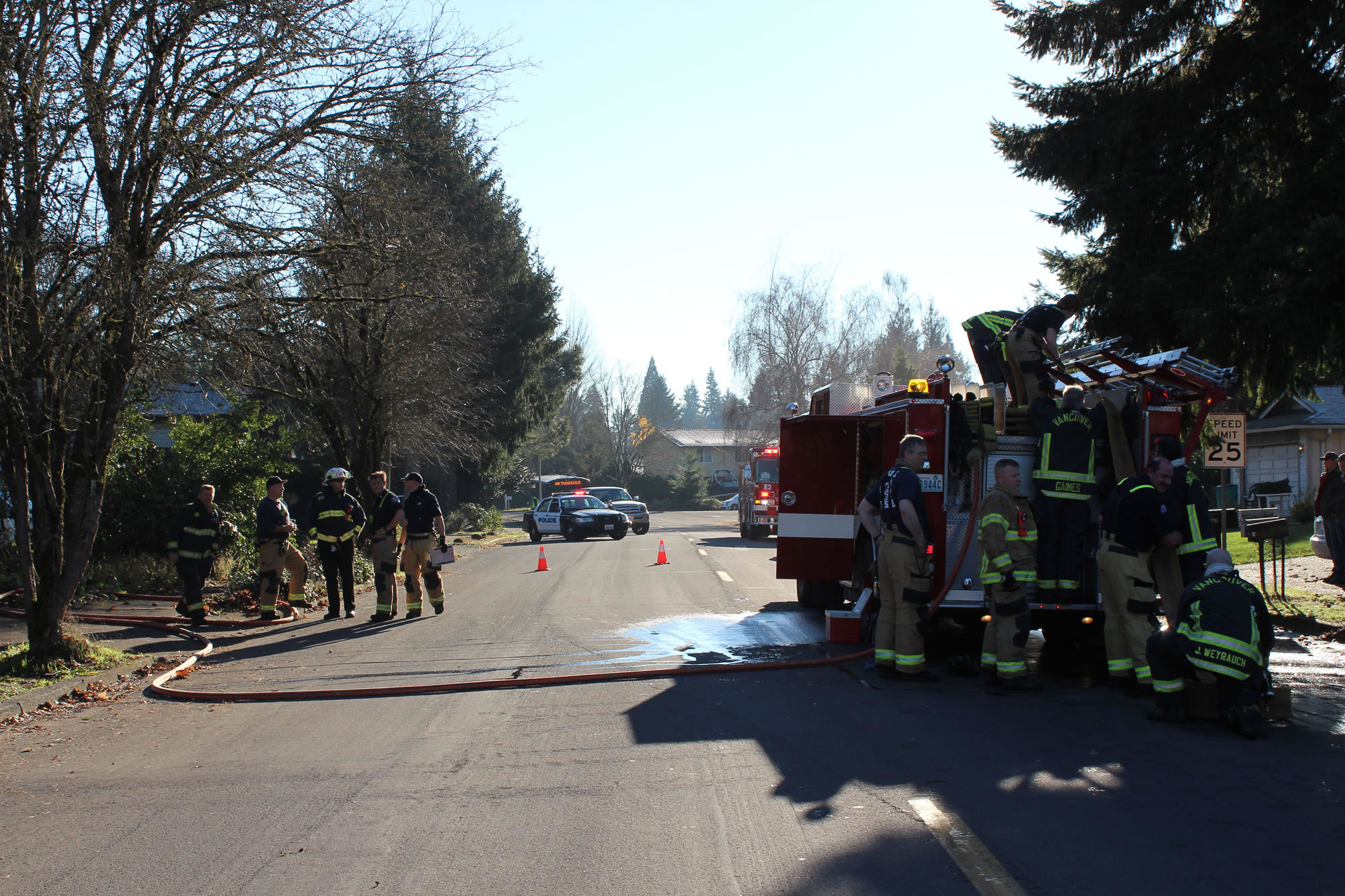 Firefighters from Fire District 6 and the Vancouver Fire Department work the scene of a house fire at Northwest Bernie Drive on Thursday, Dec. 7, 2017. A fire district spokesman said the fire was contained within five minutes.