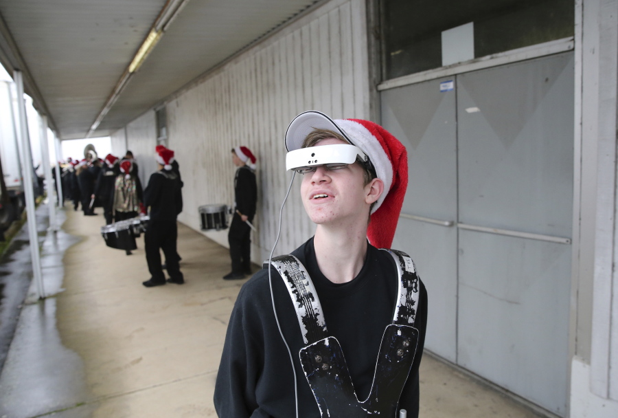 Reilly Gault, 15, who is legally blind, looks around on the first day after receiving glasses that help him to see. He marched with his band from Thurston High School at the Springfield Christmas Parade on Dec. 2 in Springfield, Ore.