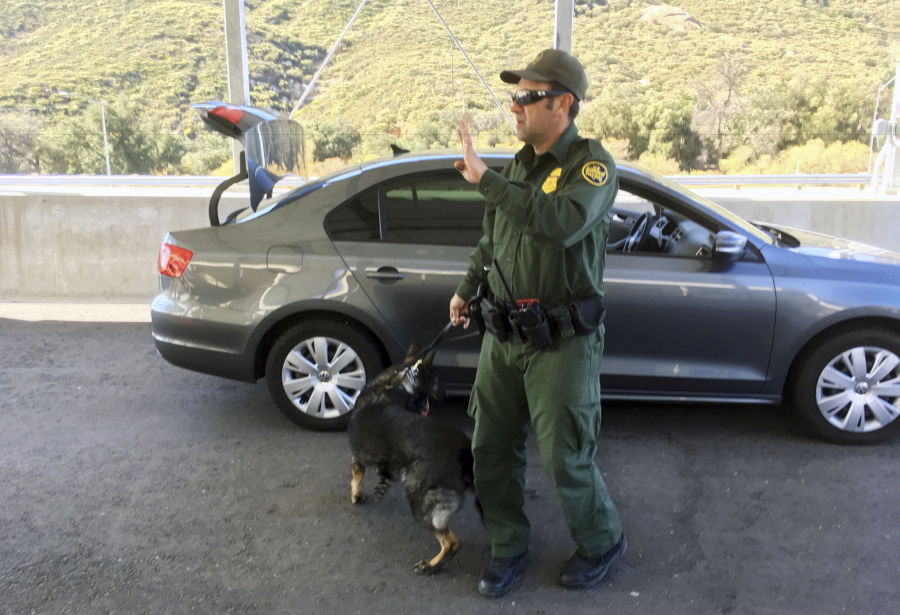 A border patrol agent stops a vehicle at a checkpoint in Pine Valley, Calif. California legalizes marijuana for recreational use on Monday, Jan. 1, 2018, but that won’t stop federal agents from seizing small amounts on busy freeways and backcountry highways. Marijuana possession will continue to be prohibited at eight Border Patrol checkpoints in California, a reminder that state and federal law collide when it comes to pot.