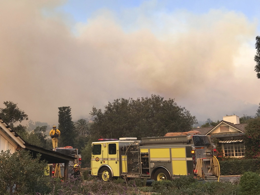 In this photo provided by the Santa Barbara County Fire Department,fire engines provide structure protection at the historic San Ysidro Ranch in Montecito, Calif., Saturday, Dec. 16, 2017. Santa Barbara County has issued new evacuation orders as a huge wildfire bears down on Montecito and other communities. The Office of Emergency Services announced the orders Saturday as Santa Ana winds pushed the fire close to the community.