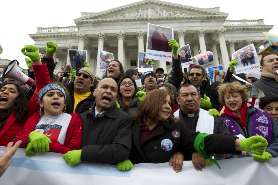 In this De. 6, 2017 photo, Rep. Luis Gutierrez D-Ill., third from left, along with other demonstrators protest outside of the U.S. Capitol in support of the Deferred Action for Childhood Arrivals (DACA), and Temporary Protected Status (TPS), programs, during an rally on Capitol Hill in Washington. House and Senate Democrats stand divided over whether to fight now or later about the fate of some 800,000 young immigrants who came to the U.S. illegally as children.