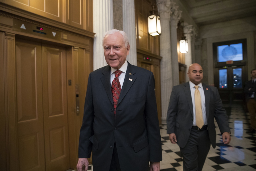 Senate Finance Committee Chairman Orrin Hatch, R-Utah, walks to the chamber as Republicans in the House and Senate plan to pass the sweeping $1.5 trillion GOP tax bill on party-line votes, at the Capitol in Washington, Monday, Dec. 18, 2017. (AP Photo/J.
