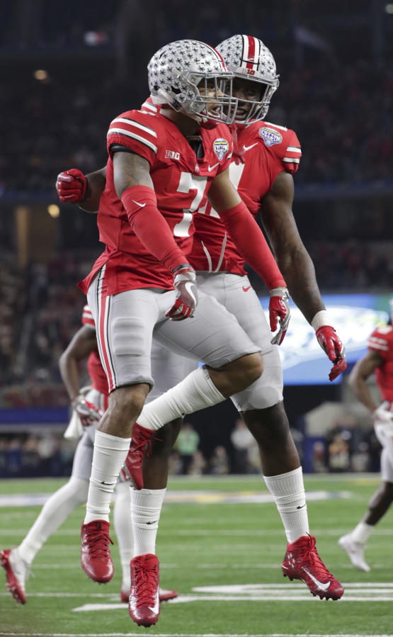 Ohio State safety Damon Webb (7) celebrates his touchdown with teammate Jalyn Holmes (11) during the first half of the Cotton Bowl NCAA college football game against Southern California in Arlington, Texas, Friday, Dec. 29, 2017.