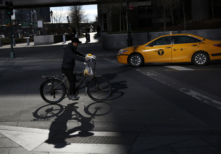 A man making deliveries rides an electronic bike in New York. A plan to intensify a crackdown on electric bicycles is causing concern among the New York City’s delivery workforce.
