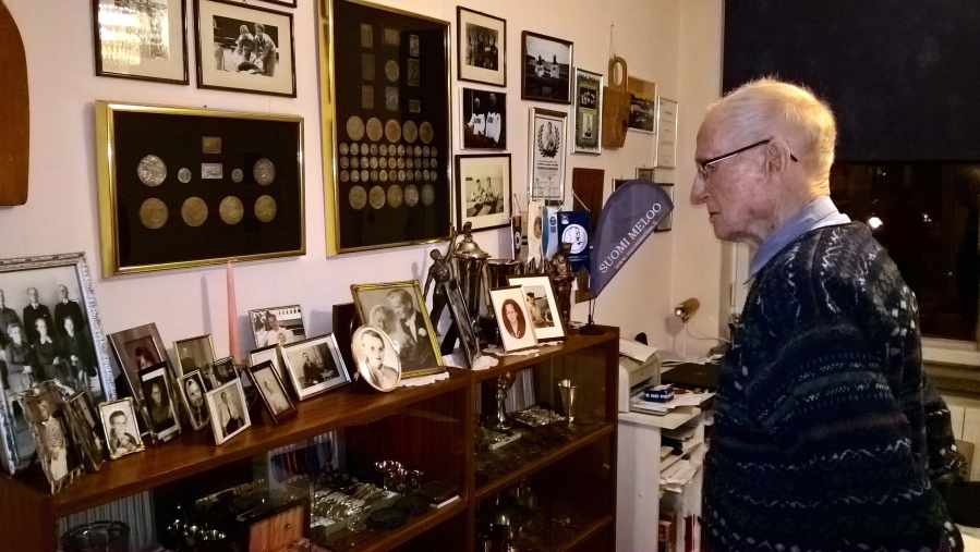Finnish World War II veteran and Olympic athlete Torsten Liljeberg, aged 101, looks over his collection of awards and prizes received in domestic and international canoeing competitions, at his home in Helsinki, Finland on Friday Dec. 1, 2017.