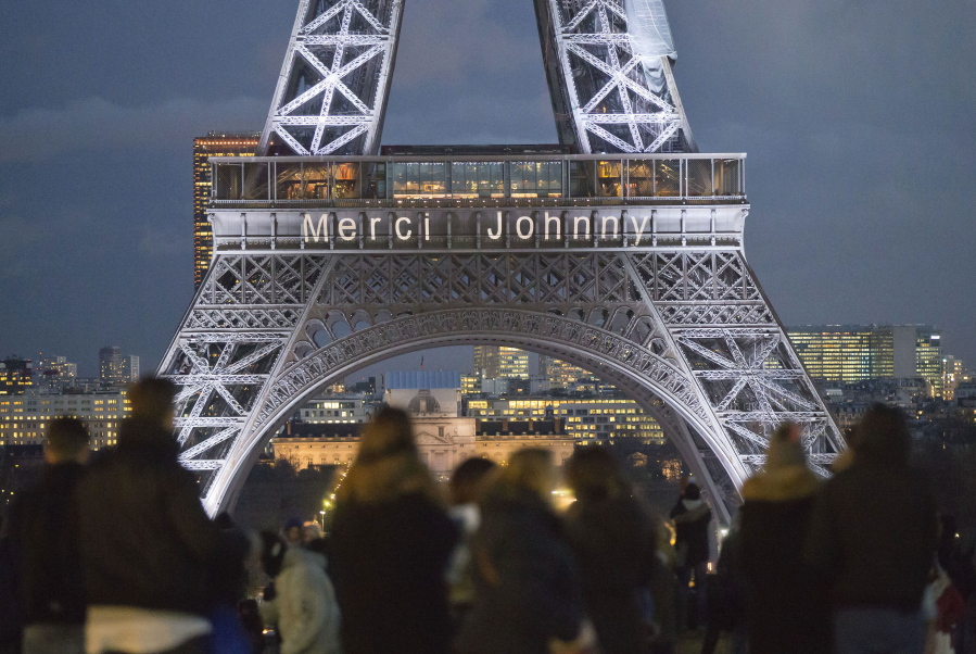 The words “Thank you Johnny” is displayed on the Eiffel Tower referring to late French rock star Johnny Hallyday in Paris, France, Friday, Dec. 8, 2017. French President Emmanuel Macron and hundreds of thousands of fans are expected to pay tribute to the late French rock star Johnny Hallyday on Saturday as his funeral procession weaves through Paris.