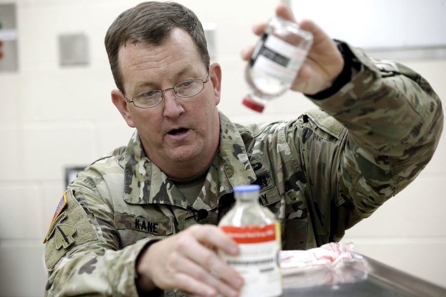 In this Wednesday, Nov. 8, 2017 photo, U.S. Army Col. Shawn Kane demonstrates the use of freeze-dried plasma in the military at Fort Bragg, N.C. All of the U.S. military’s special operations fighters sent off to warzones and raids now have the essential addition to their first-aid kits. The plasma helps clot blood and can prevent badly wounded troops from bleeding to death on the battlefield.