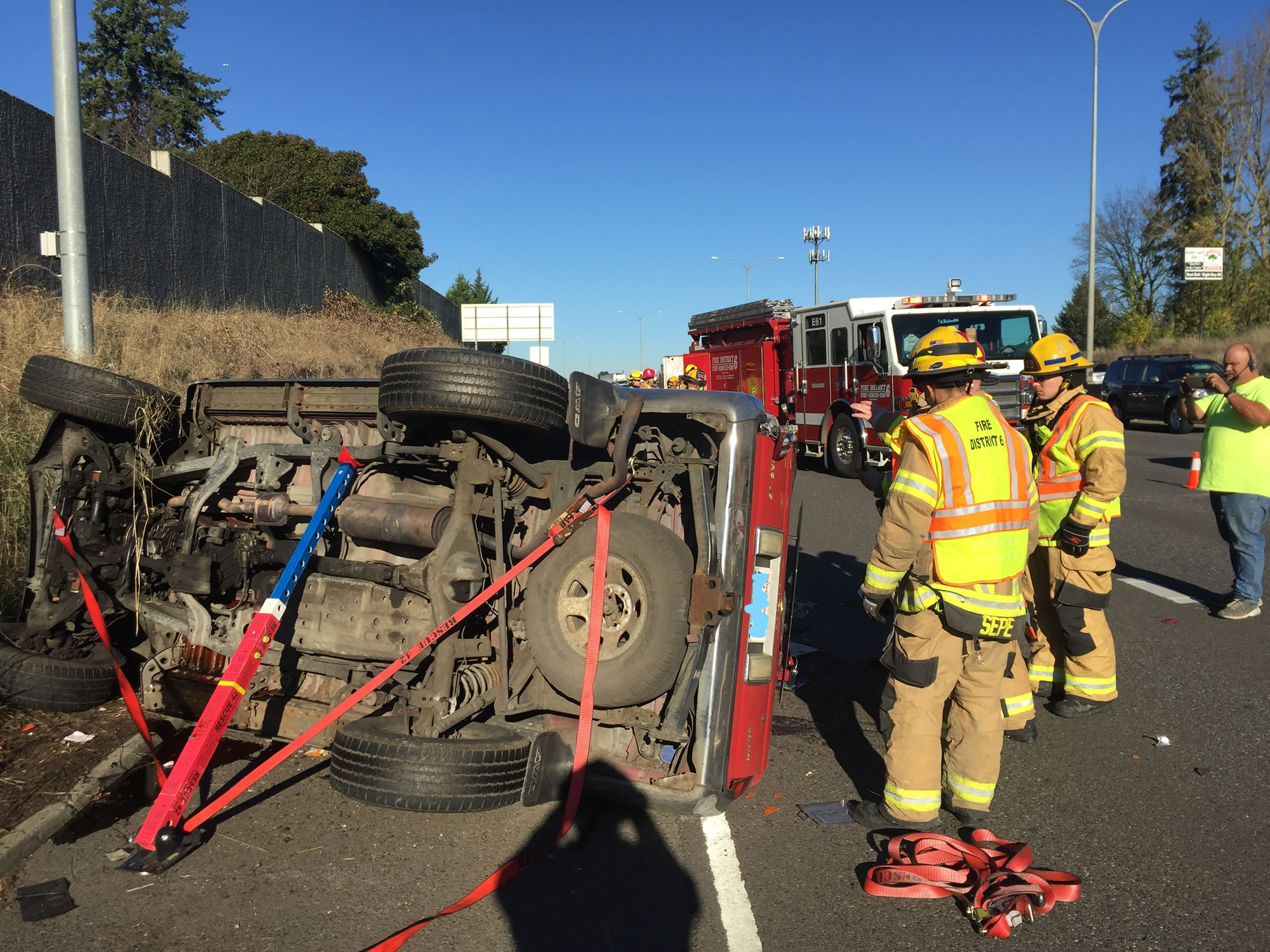 Clark County Fire District 6 firefighters work the scene of a three-vehicle crash on Interstate 5 just south of the 78th Street onramp Tuesday, Dec. 5, 2017.