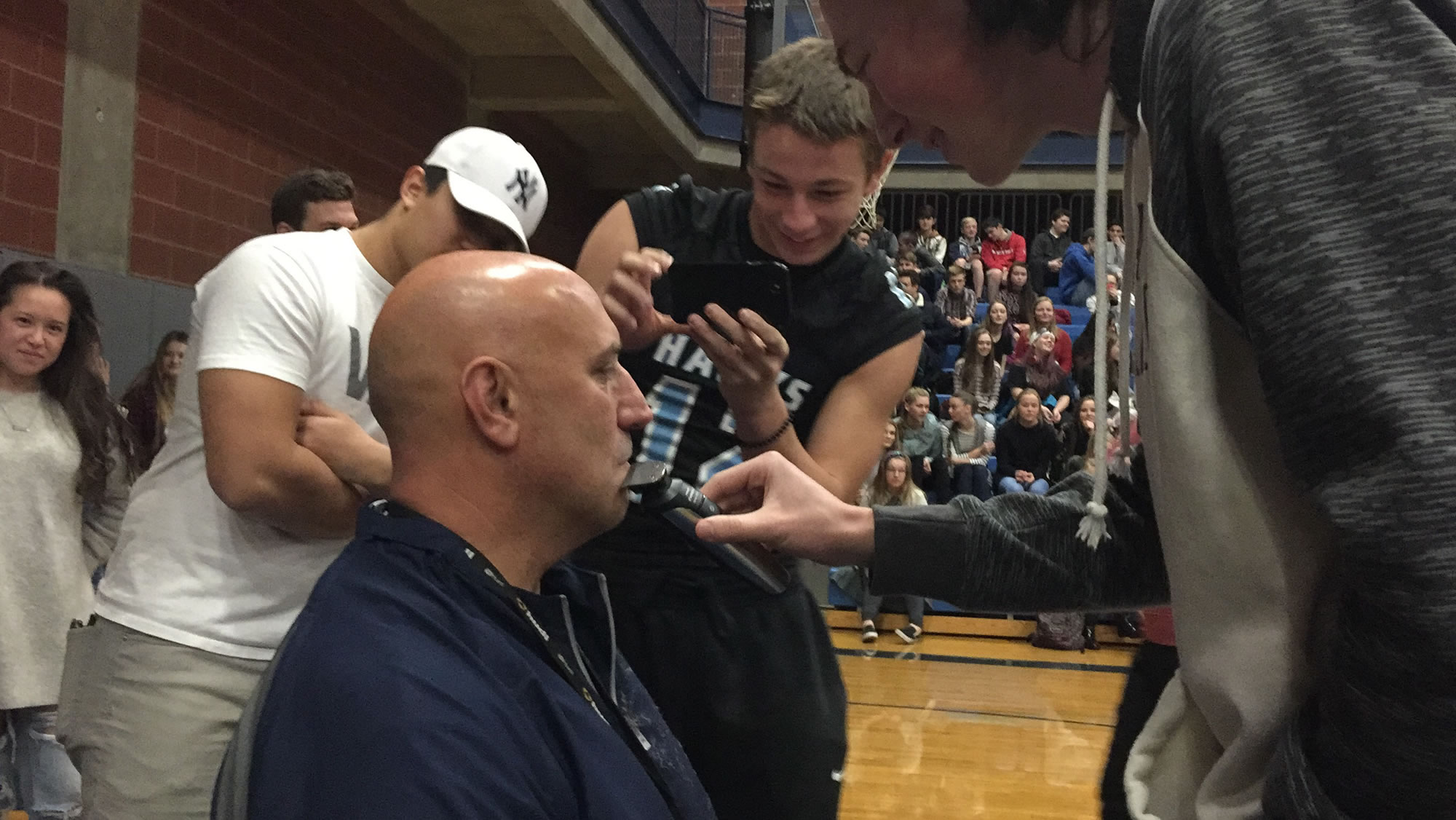 Hockinson football coach Rick Steele, as a part of a bet, had his mustache shaved by his players after they presented the state championship trophy to the high school on Friday, December 15.