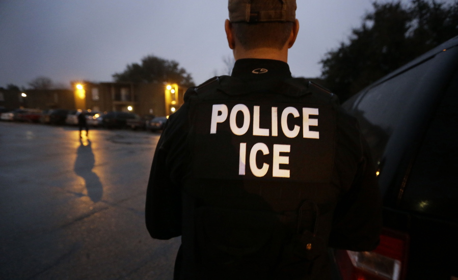 U.S. Immigration and Customs Enforcement agents enter an apartment complex in 2015 looking for a specific undocumented immigrant convicted of a felony during an early morning operation in Dallas. On Tuesday, the federal government provided the most complete statistical snapshot of immigration enforcement under President Donald Trump, showing Border Patrol arrests plunged to a 45-year low.