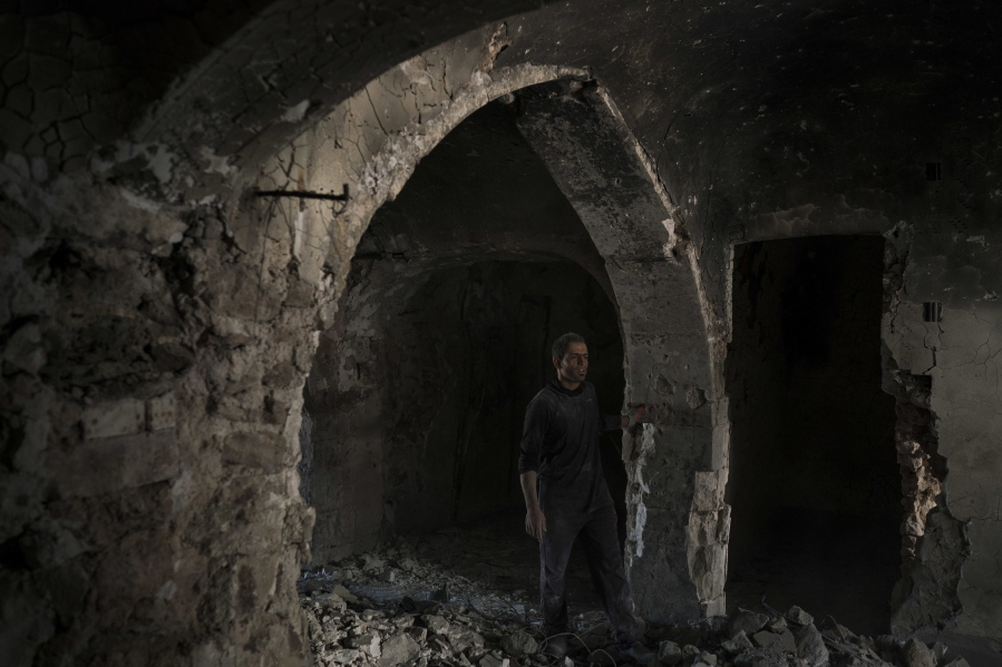 A construction worker stands in the destroyed old bazaar in the Old City of Mosul, Iraq. The scope of destruction in the neighborhood is comparable to some of the worst urban battles of World War II, and the cost of rebuilding is nearly incalculable.