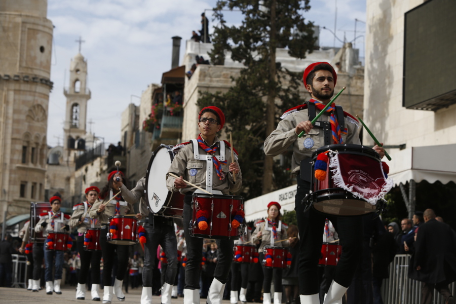 Members of a Palestinian marching band parade during Christmas celebrations Sunday outside the Church of the Nativity in Bethlehem.