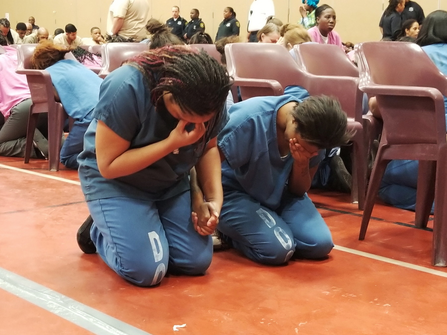 Inmates at Cook County Jail kneel to pray during Christmas Day services with the Rev. Jesse Jackson on Monday in Chicago. The civil rights leader disclosed a 2015 diagnosis of Parkinson’s disease last month.