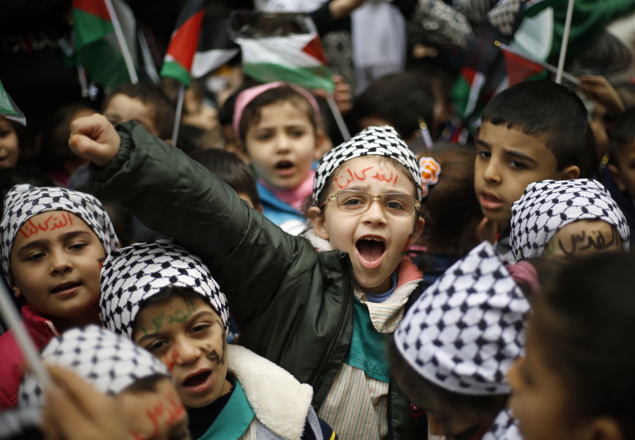 A girl with Arabic painted on her face that reads, "Jerusalem is for us," chants slogans during a sit-in in the Bourj al-Barajneh Palestinian refugee camp, in Beirut, Lebanon, Wednesday, Dec. 6, 2017. President Donald Trump is forging ahead with plans to recognize Jerusalem as Israel's capital despite intense Arab, Muslim and European opposition to a move that would upend decades of U.S. policy and risk potentially violent protests.