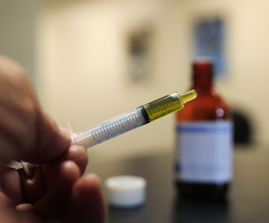 A syringe loaded with a dose of CBD oil is shown in a research laboratory at Colorado State University in Fort Collins, Colo.